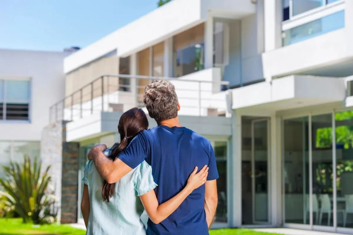 Couple Standing Outside Dream Home